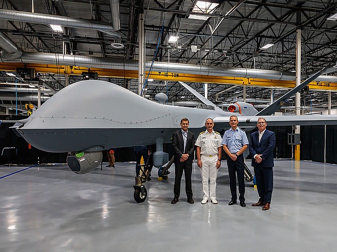 Photo courtesy of General Atomics Aeronautical Systems Inc. 
General Atomics Aeronautical Systems Inc. hosted a roll-out event for the Royal Netherlands Air Force in early July, marking the completion of the country’s first MQ-9A Block 5 remotely piloted aircraft. Seen on the factory floor are GA-ASI CEO Linden Blue (left) Vice Adm. Arie Jan De Waard, Lt. Gen. Dennis Luyt and GA-ASI President David R. Alexander.